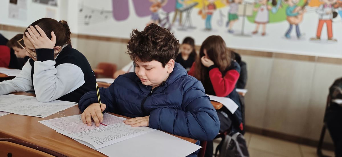 Elementary students concentrating on work at their desks in a classroom
