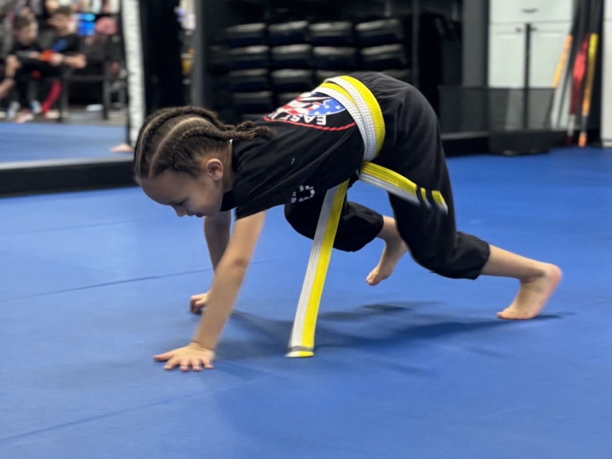 Young student doing push-up drill during martial arts training at Trevose